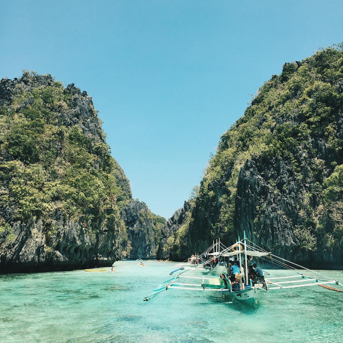 Explore El Nido's breathtaking lagoon with turquoise waters and lush cliffs, a perfect tropical getaway.