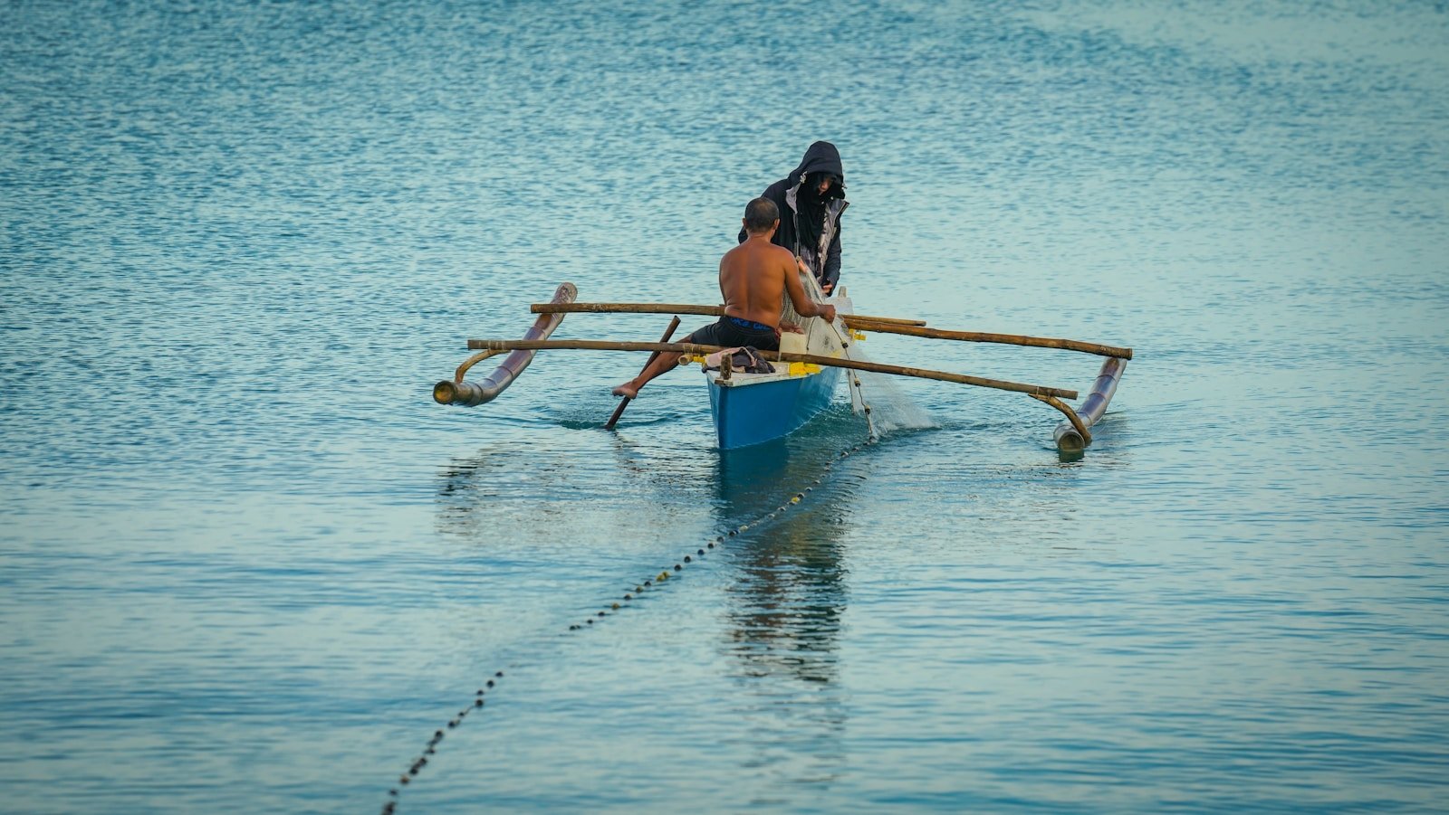 Photo by Josephus Bajo a couple of people in a boat on the water